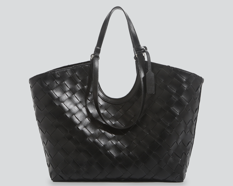 A black woven leather tote bag with double top handles, shown against a solid light gray background.